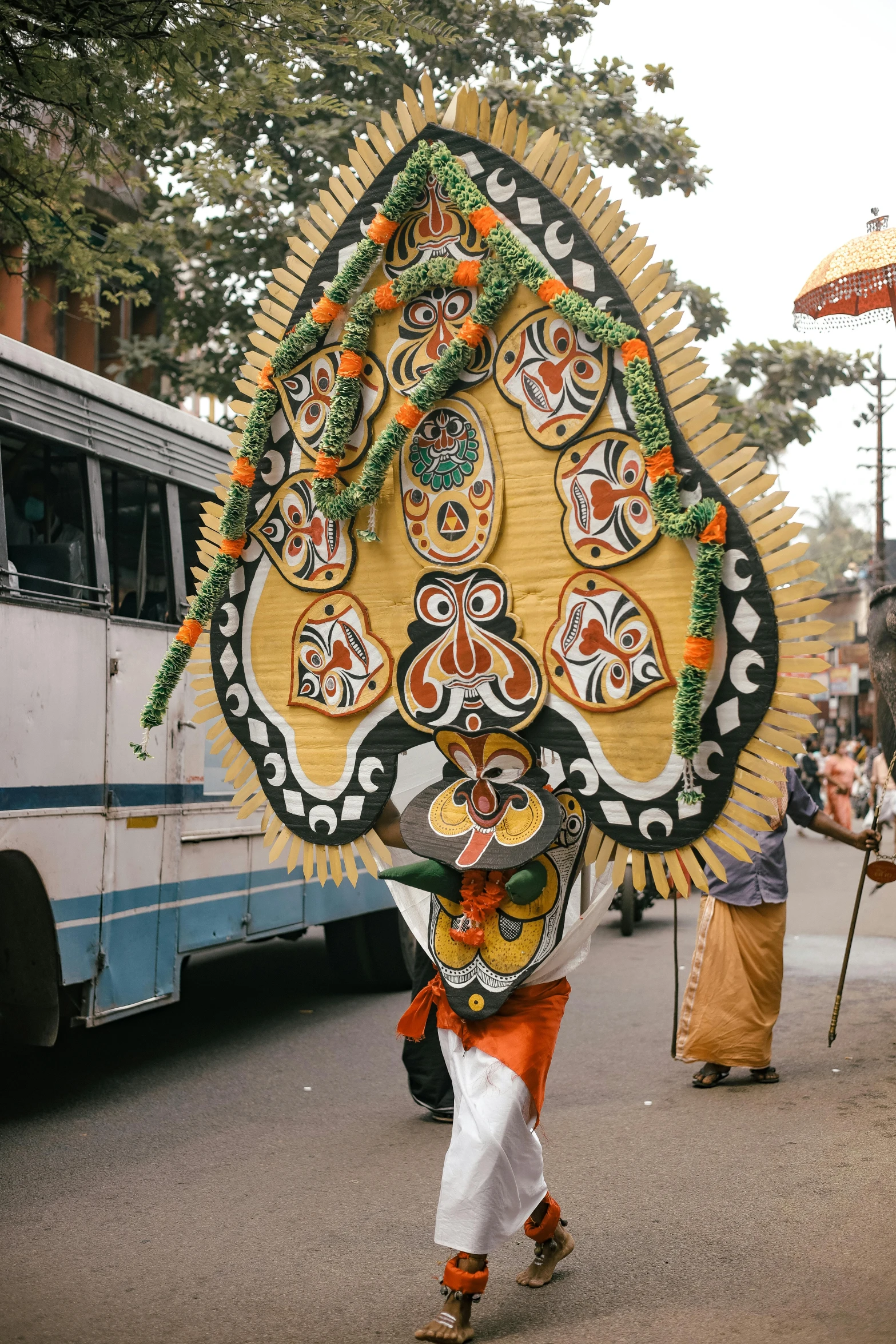 a large elaborately decorated object is being carried along the street