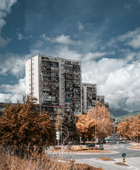 a city street in front of some buildings and trees