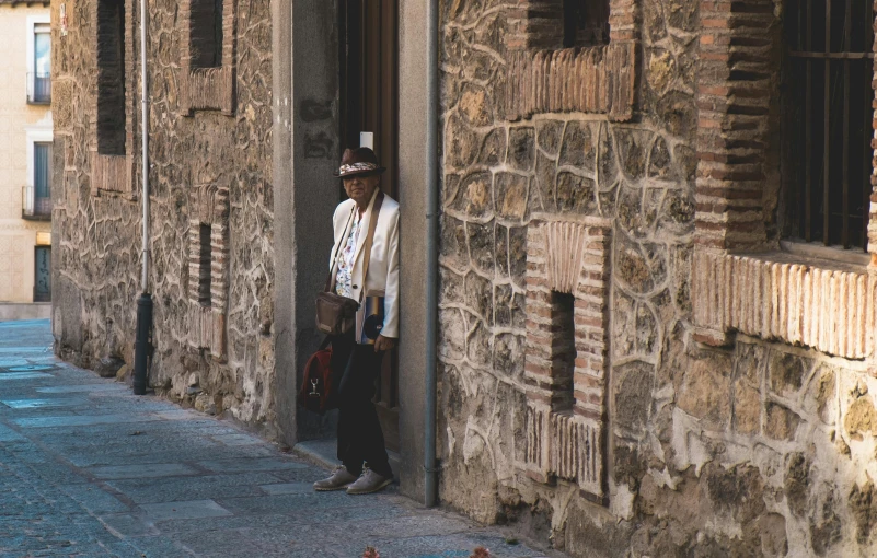 two people standing outside a large brick building