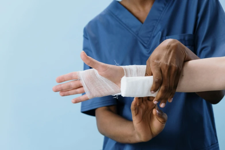 a person with gloves and bandages on their hands