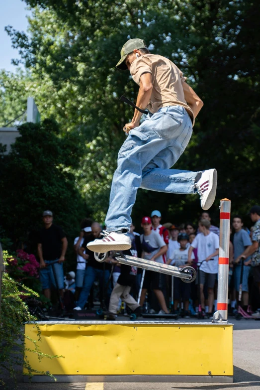 a man doing tricks on his skateboard on a yellow barrier