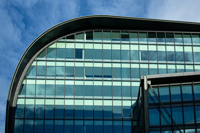 a building with windows and blue sky reflected on it