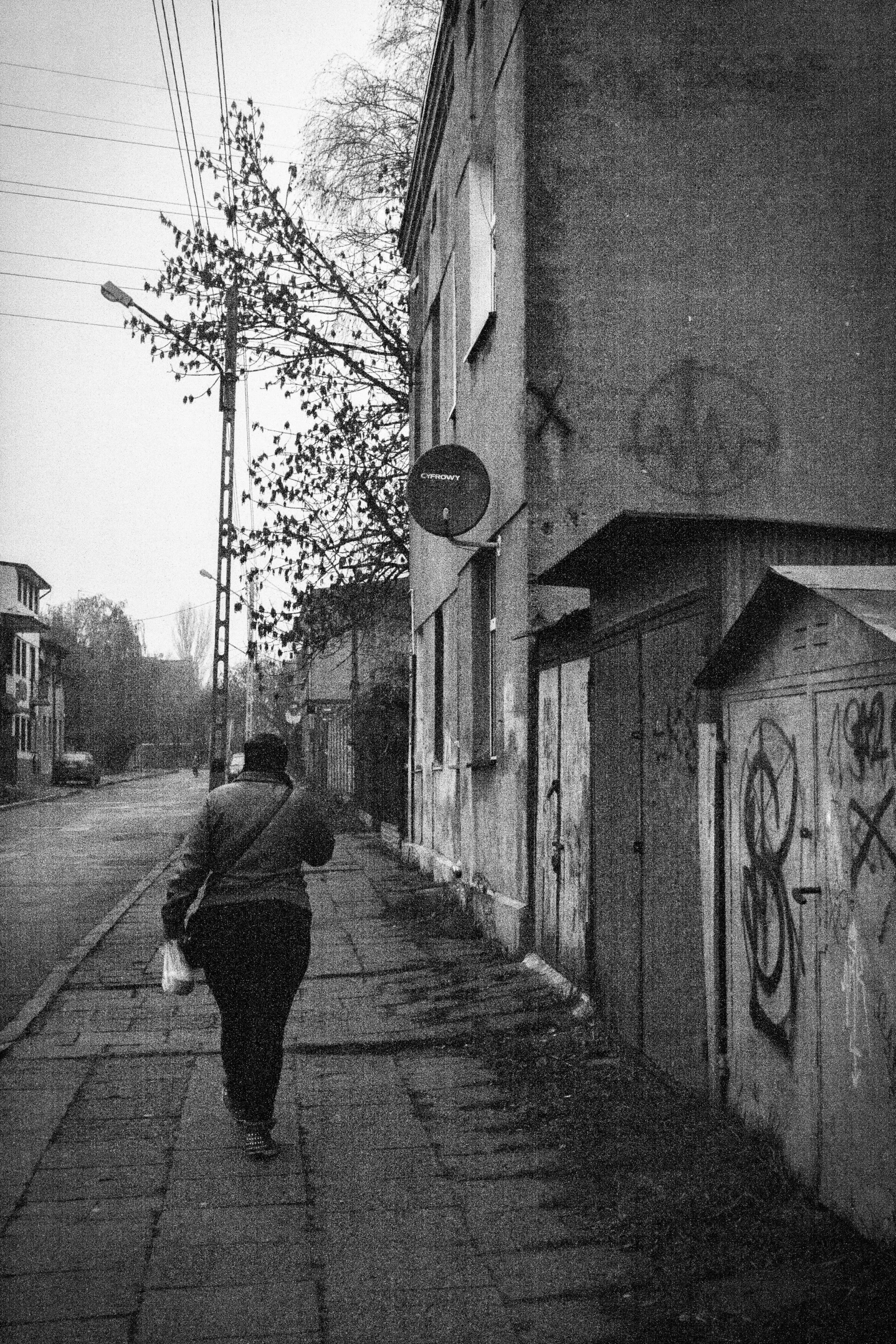 a person walking on a street in the rain