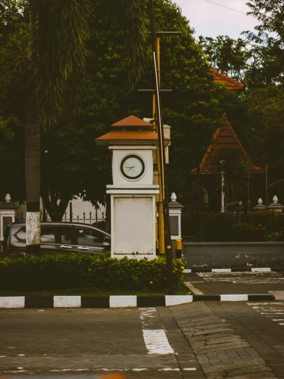 an old clock tower on the side of the road