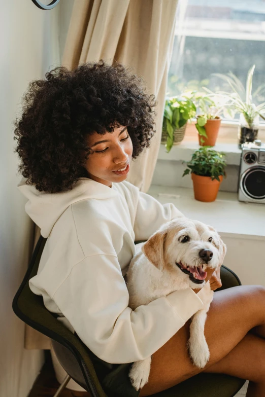 a woman holding a dog on her lap