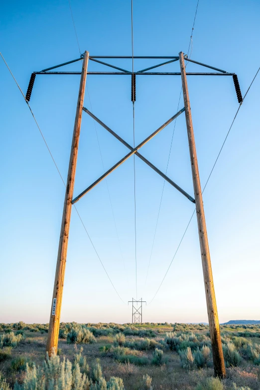 the power line crosses over the desert floor