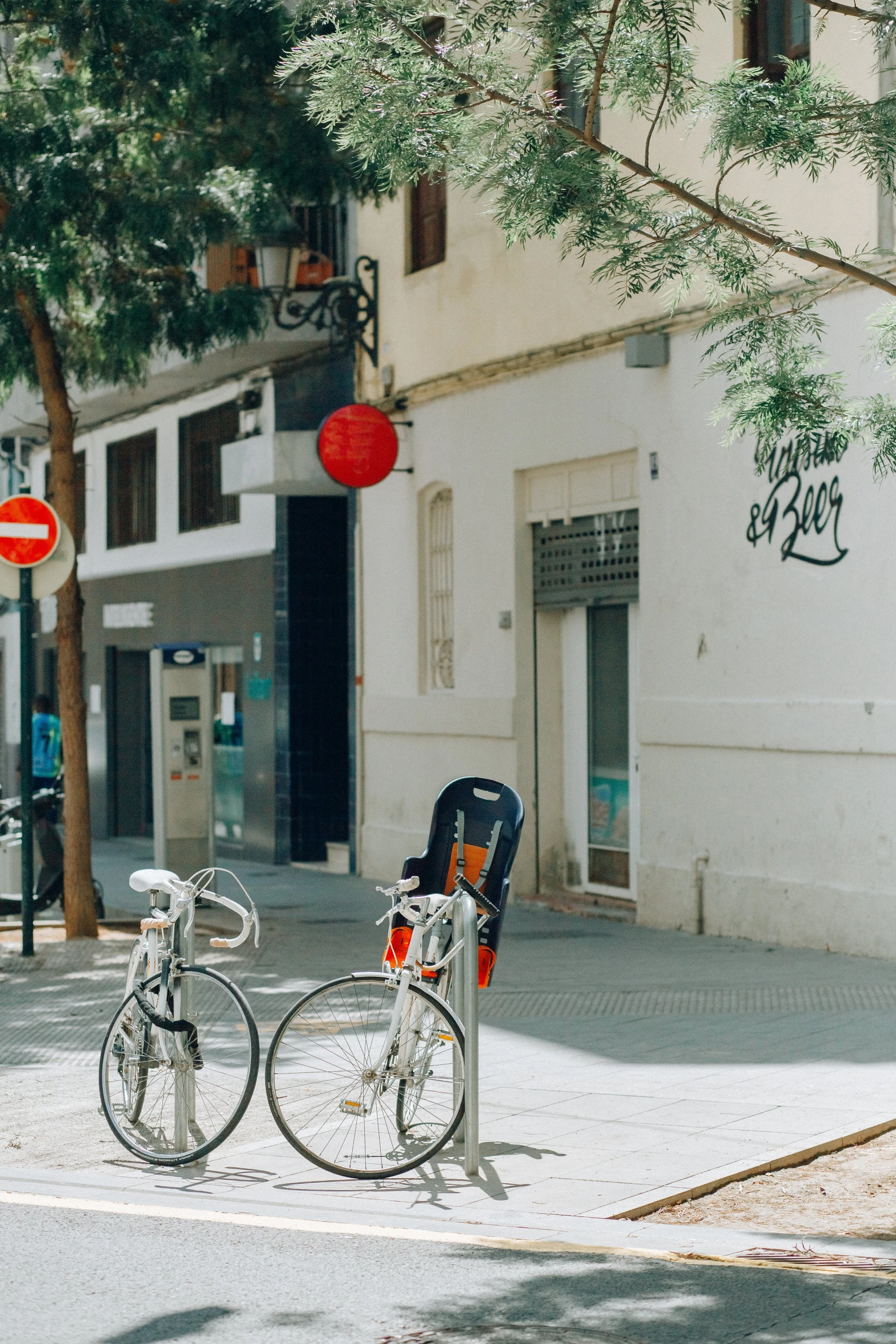 two bicycles parked side by side on a city street