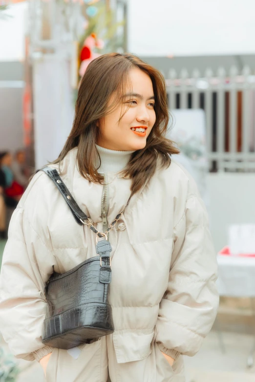 a girl with a fake tooth and a black purse