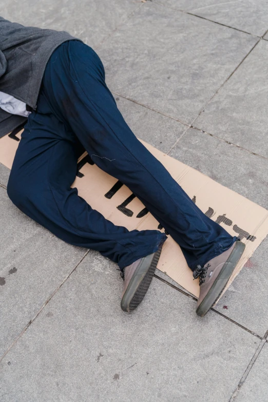 a man laying on the ground wearing a suit and tie