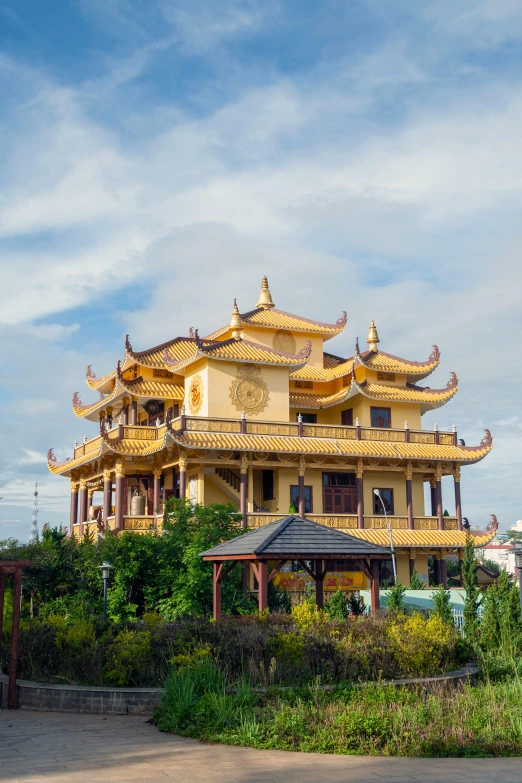 the yellow architecture on a building sits in front of trees