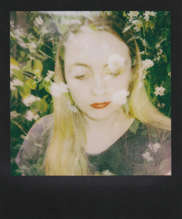 woman in front of white flowers with large eyes