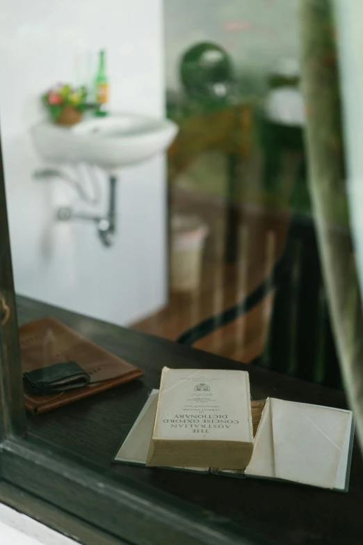 a box sitting on top of a wooden table next to a mirror