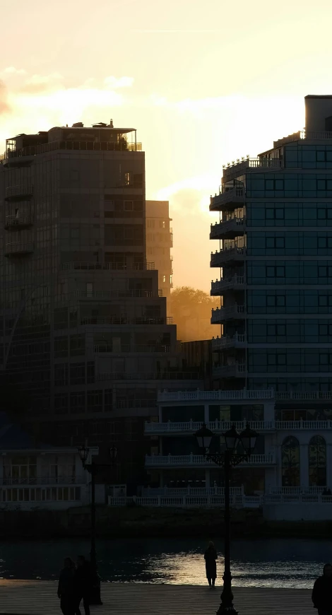 a body of water in front of some tall buildings