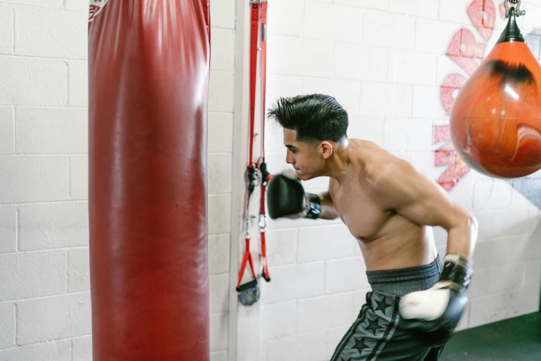 a man hitting a ball in a gym