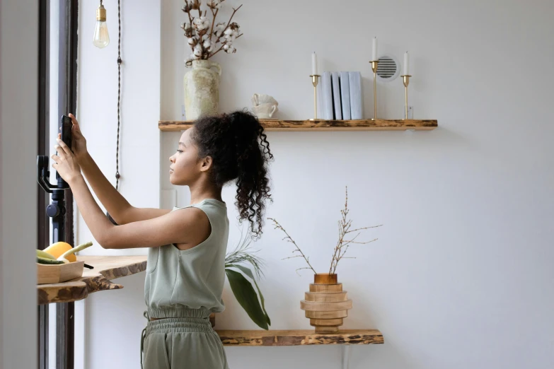 a woman is putting together some shelves and other items