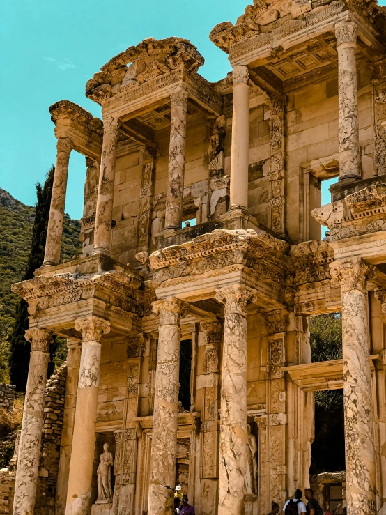 people walk through the ruins of an old building