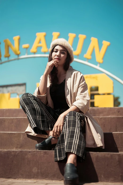 a woman sitting on some steps talking on her cell phone