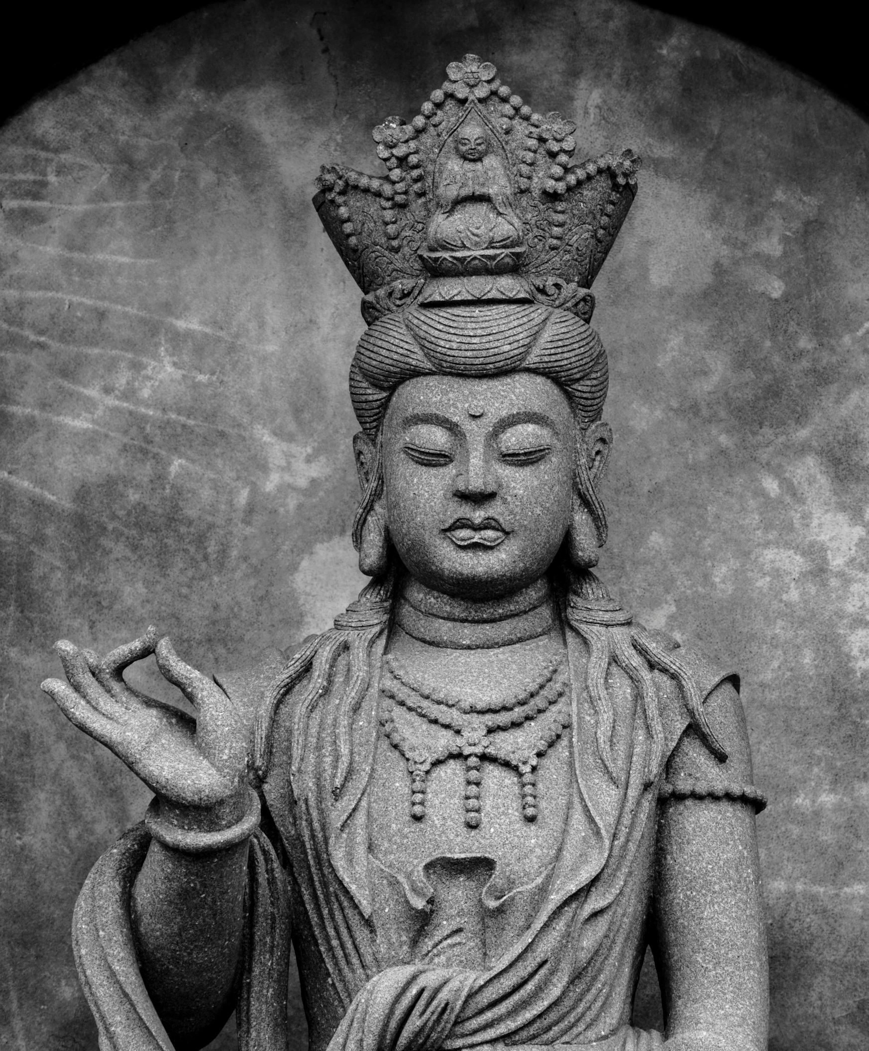 buddha statue with his hands raised next to his head