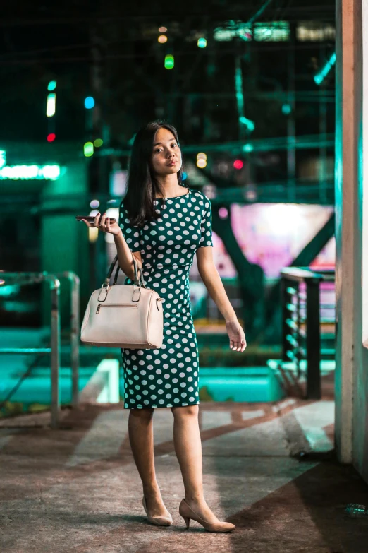 a woman with long hair carrying a white purse