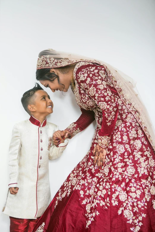 a bride and groom smile as they pose together