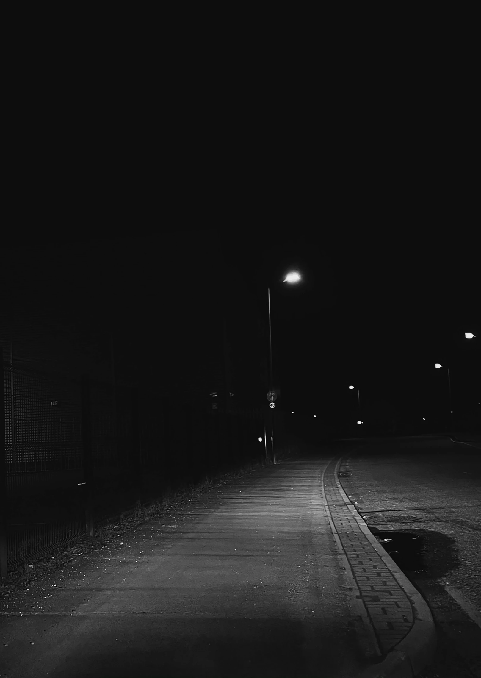 an empty street that is lit up at night