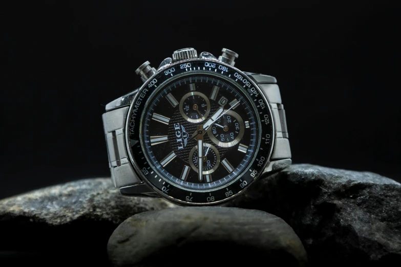 a watch sitting on top of a rock