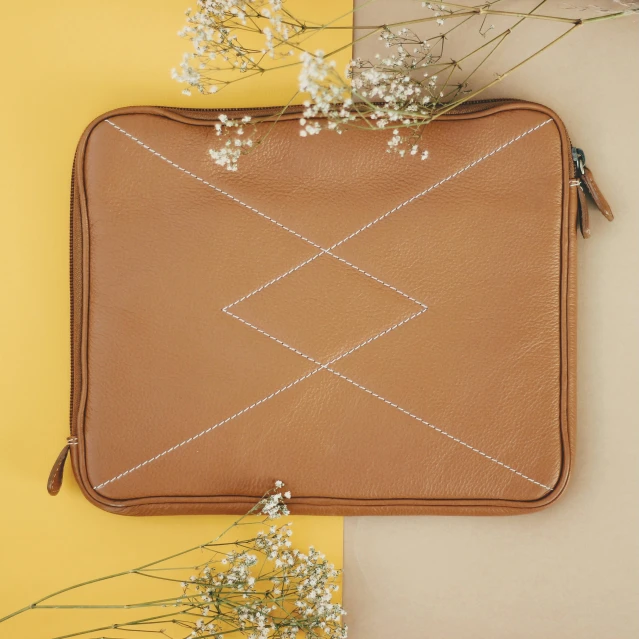 an open purse sitting on top of a yellow and beige wall