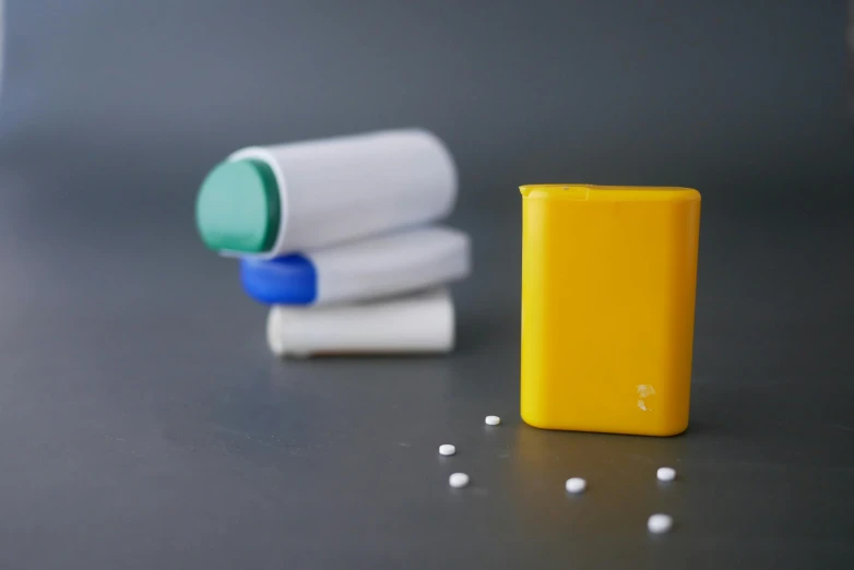 three toothbrushes with some blue and yellow in front of them