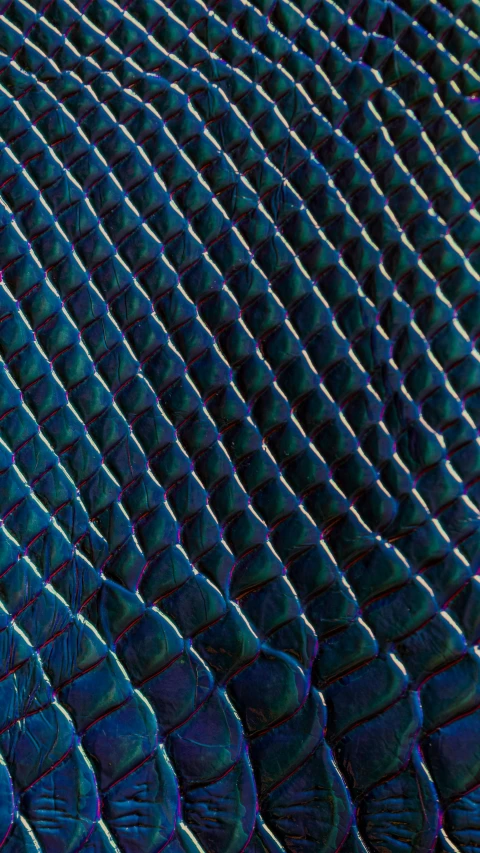 a large pattern of blue scales on top of each other