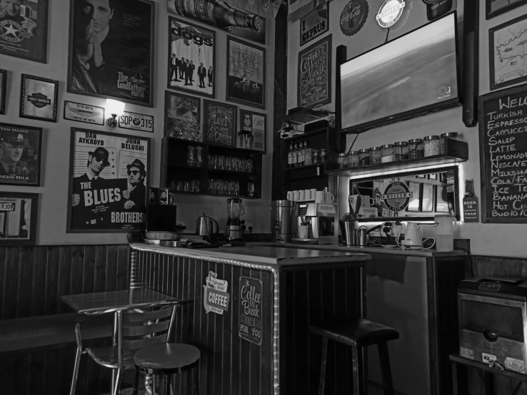 a man sitting in a bar next to a tv