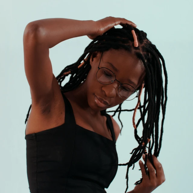 a woman with dreadlocks posing for the camera