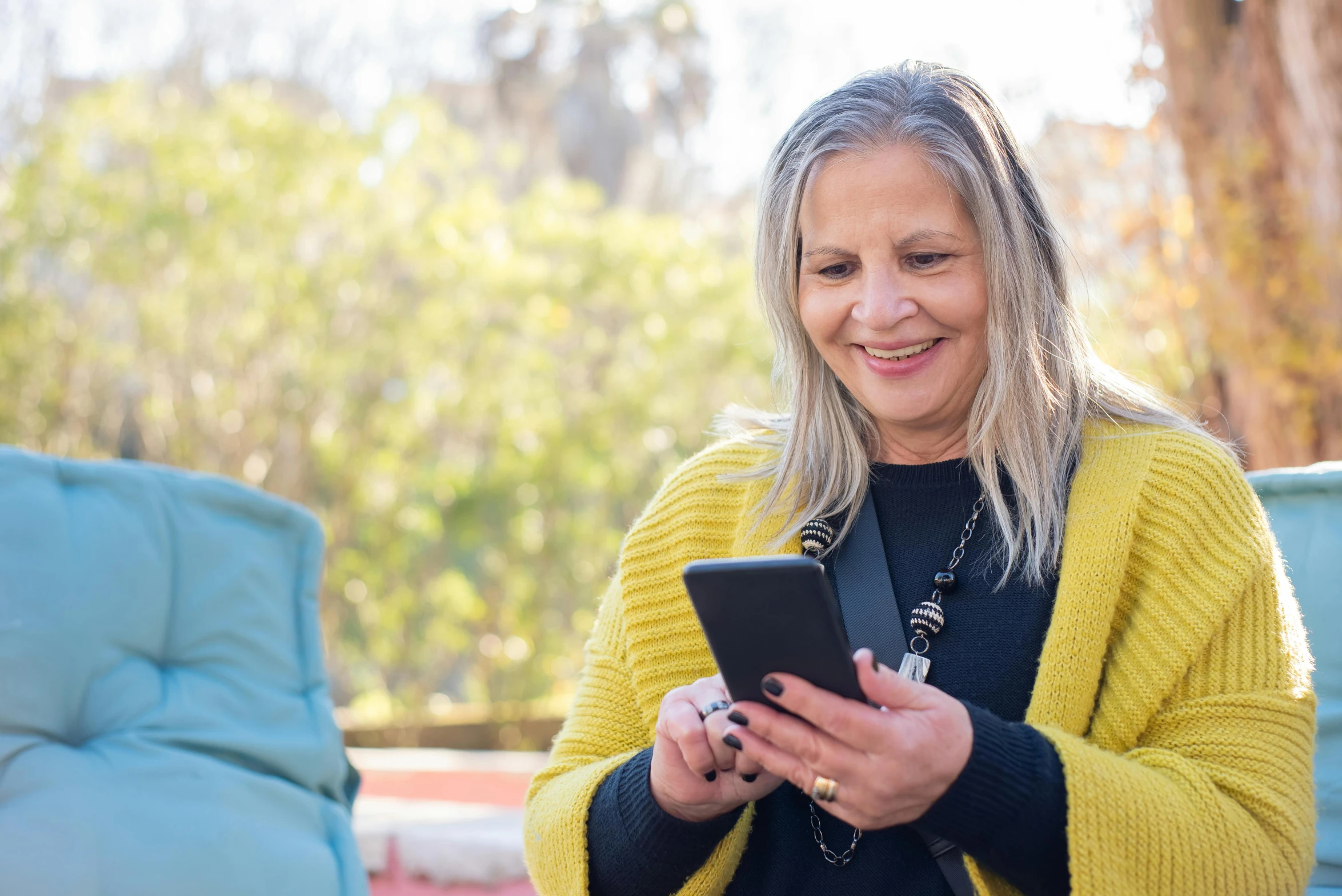 woman sitting on chair and looking at tablet computer