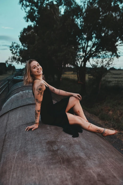 the woman is posing with tattoo on her body and tattoos