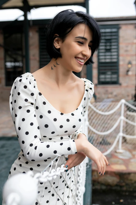 a young woman is wearing a polka dot dress