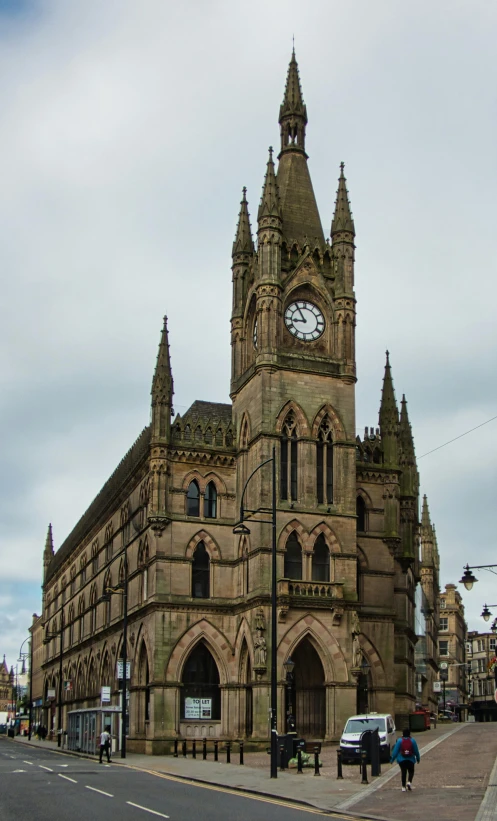 an old cathedral style building with a clock on the top