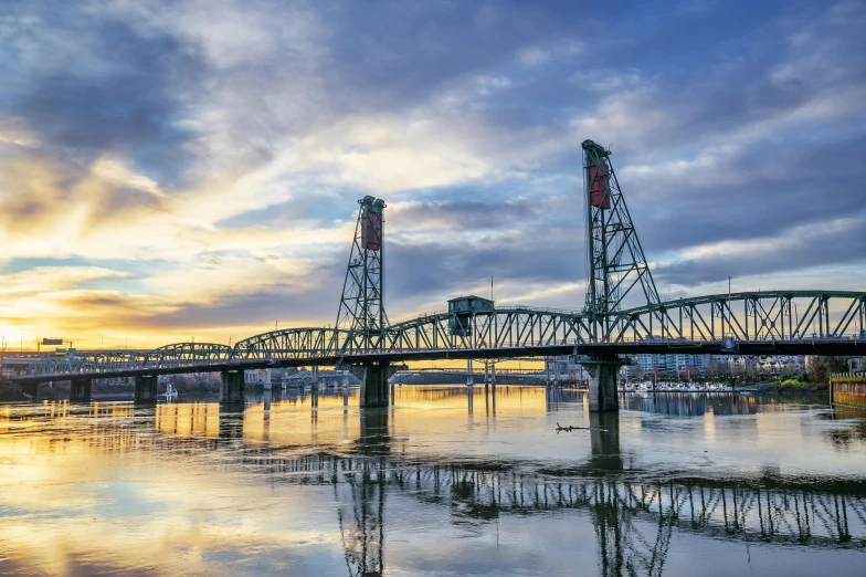 bridge with tall tower sitting over water