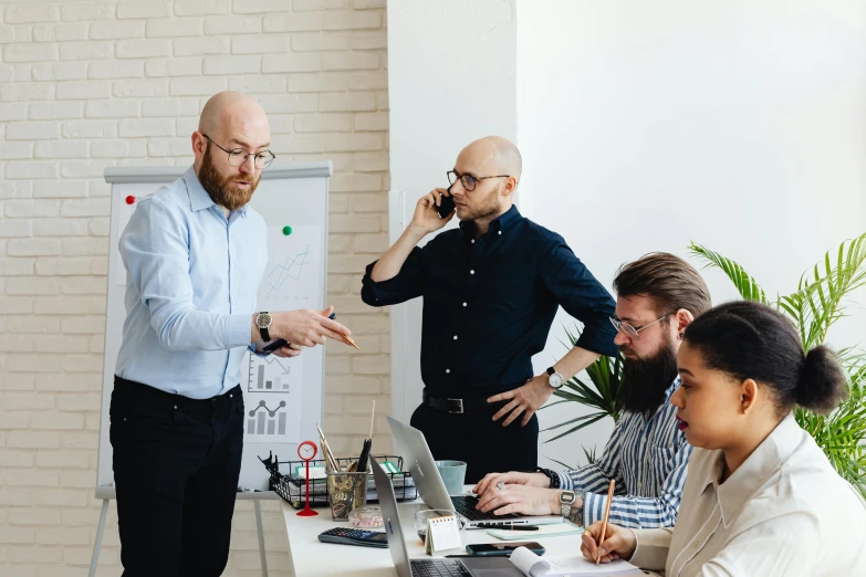 three professionals in an office having a discussion