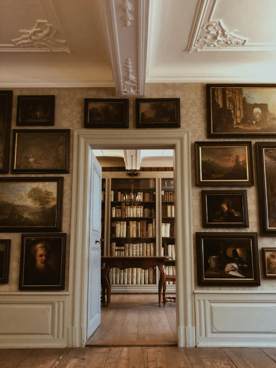 an arched doorway with pictures on the walls