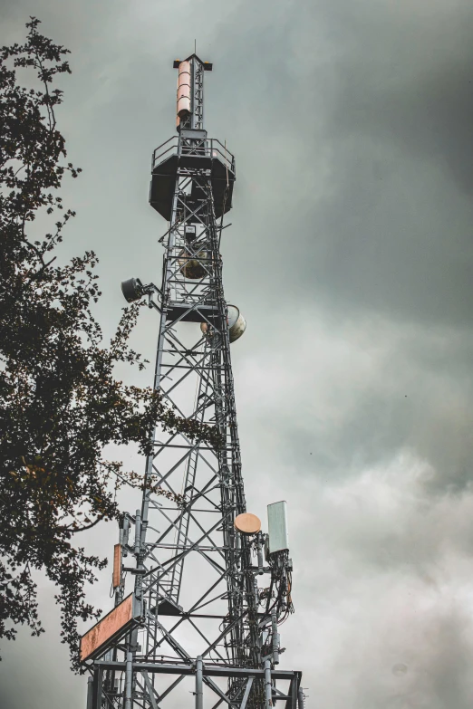 a tower is in the middle of the cloudy sky