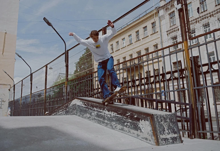 a young man riding a skateboard up a metal railing