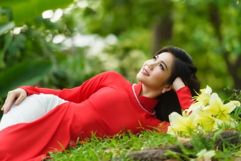 a woman in red is laying on the ground