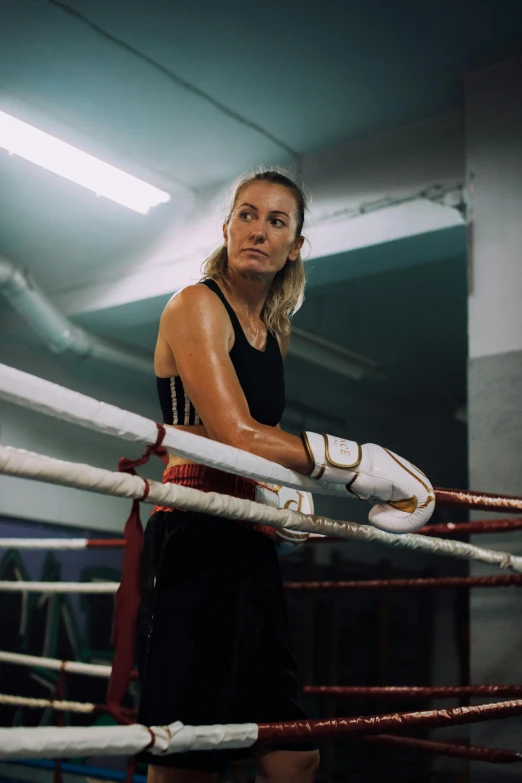 a woman boxer in a ring wearing boxing gloves
