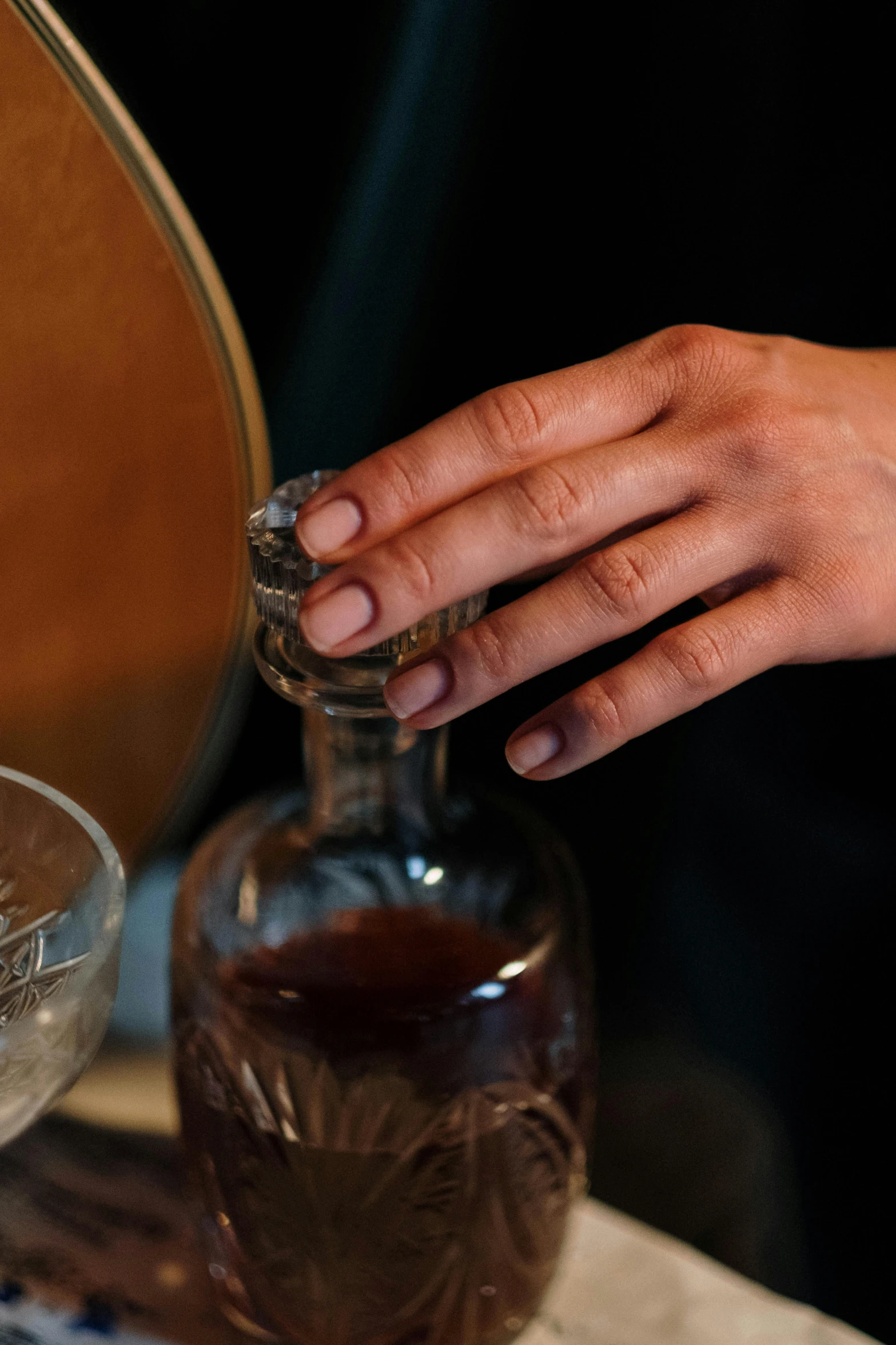 a hand is taking out soing from a bottle