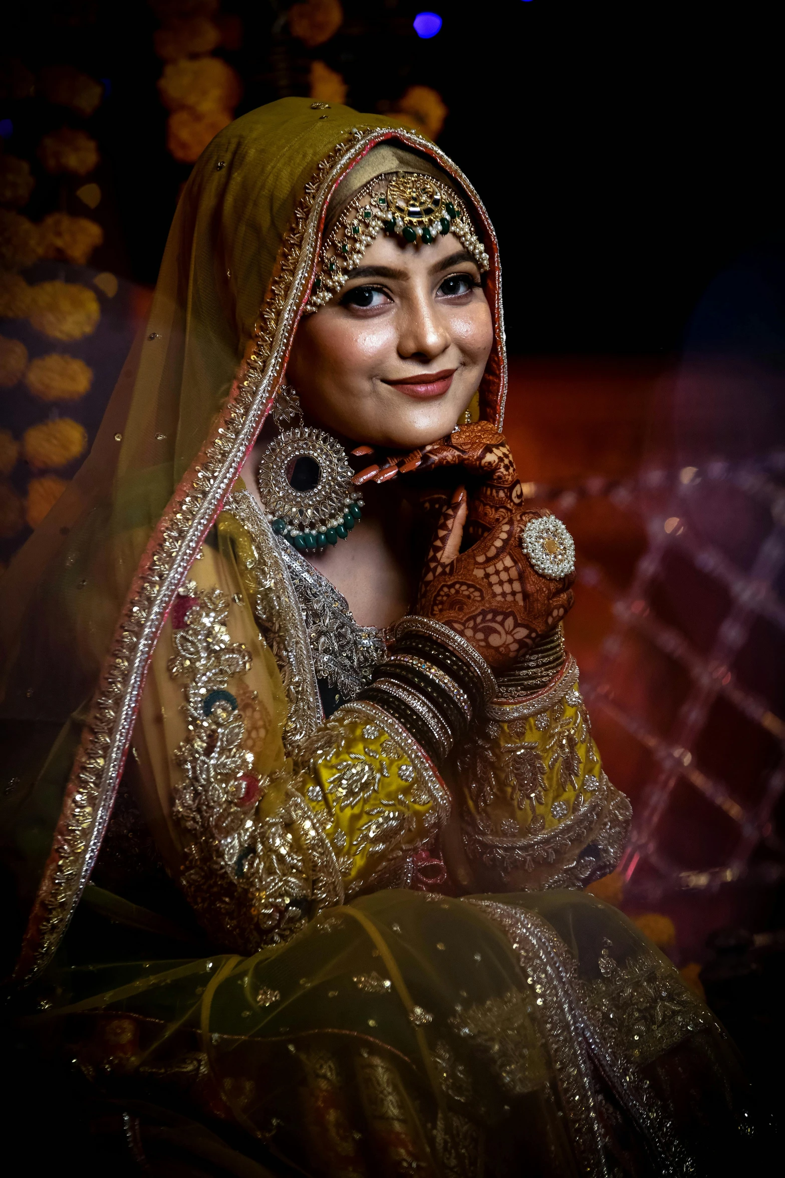 woman dressed in elaborate indian garb sitting down