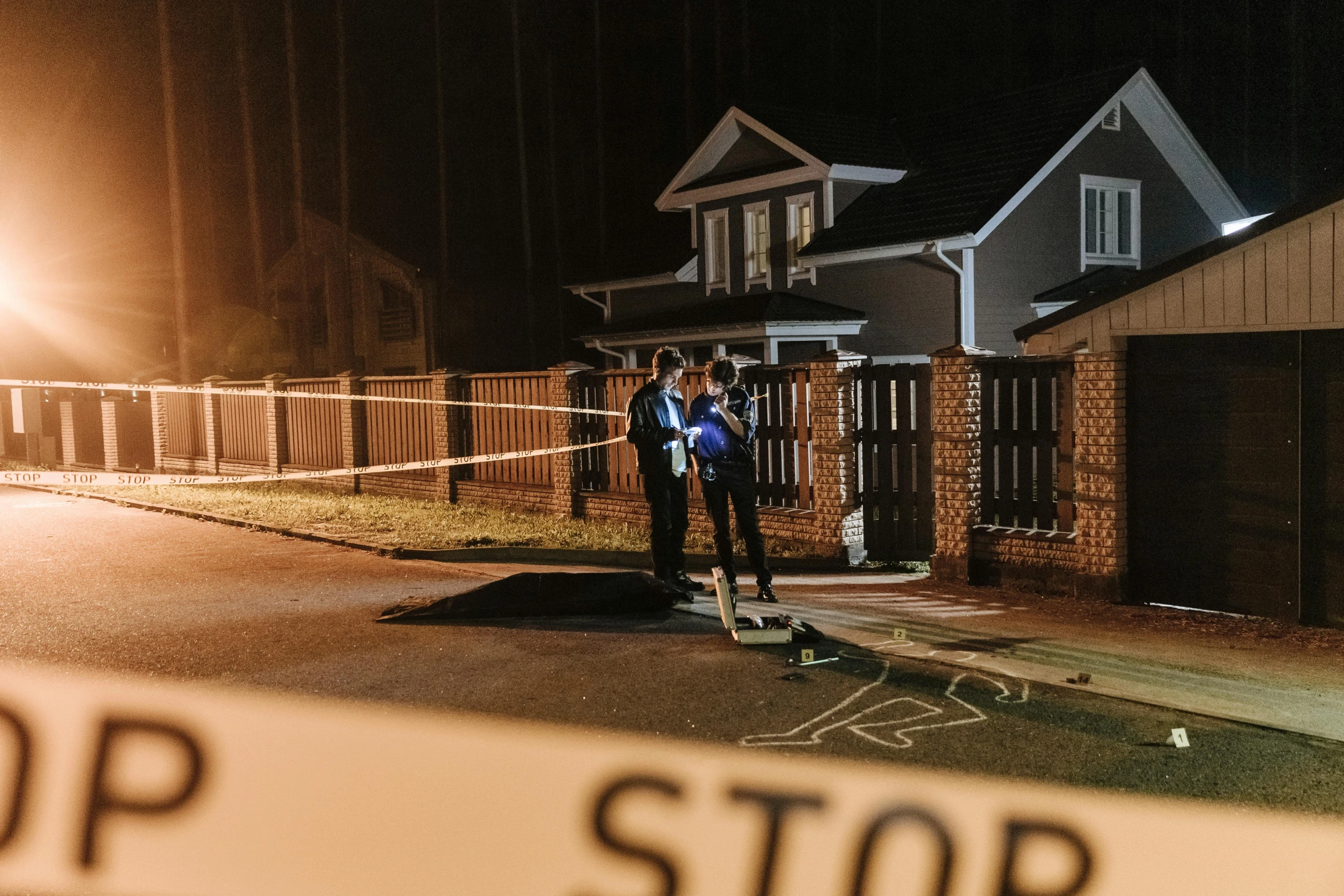 police stand in front of a house where an unknown man was found