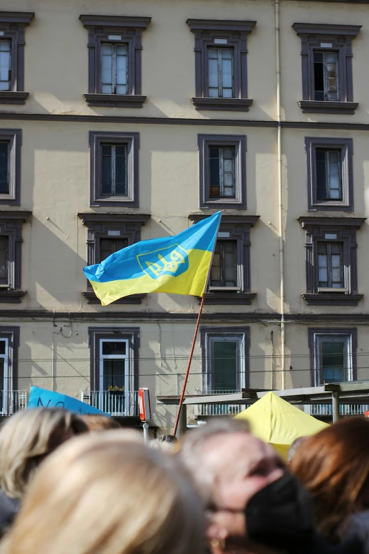 a small blue and yellow umbrella at an event