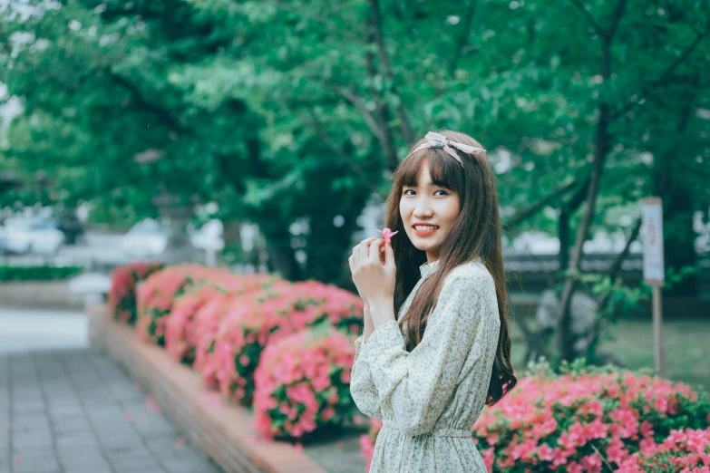 an asian woman in a dress talking on the phone