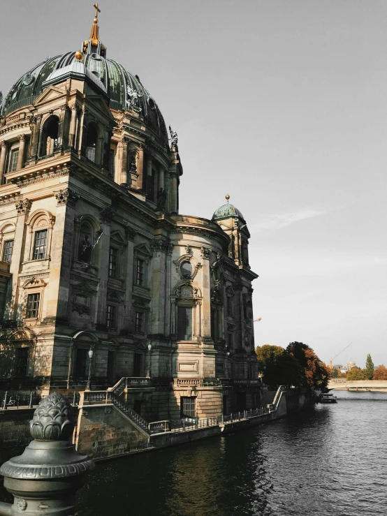 the front of an old european church with a lake in front