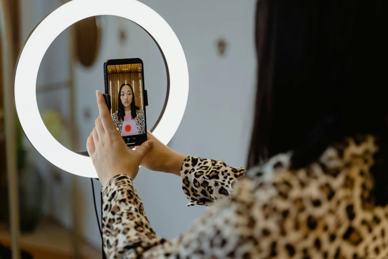 a person holding up a phone in front of a mirror