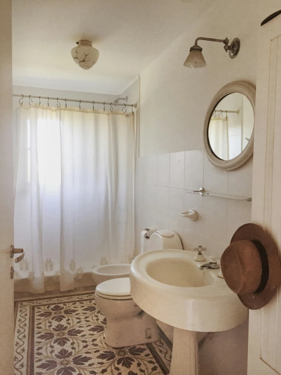 a bathroom with white walls and an area rug